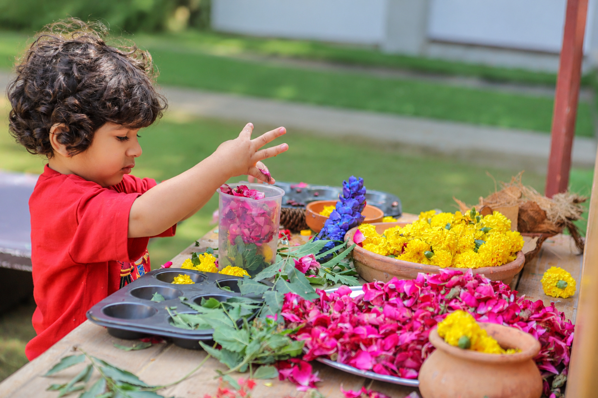 Young children exploring materials with an educator
